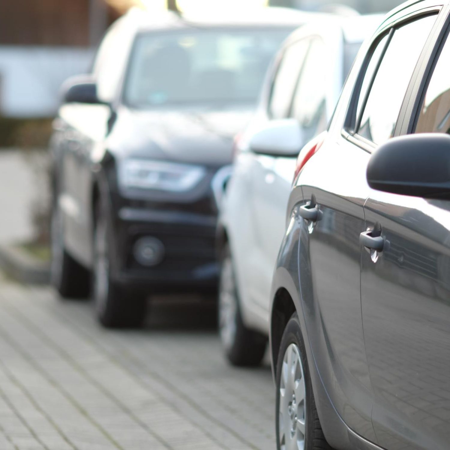 closeup-shot-black-car-parking-lot-with-blurred-background (1)