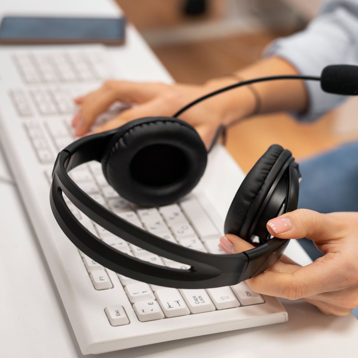 woman-working-call-center-holding-pair-headphones (1)